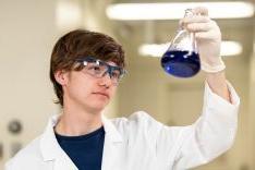 Student wearing lab coat in research lab