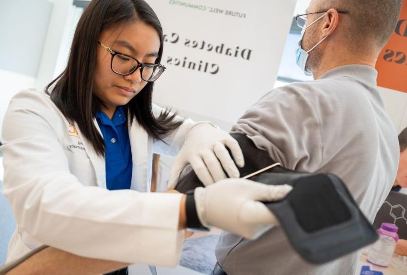 a student works with a patient at a diabetes care clinic